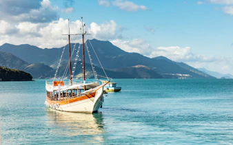 Schooner sailing in Angra dos Reis bay with Ilha Grande mountains, Rio de Janeiro, Brazil.