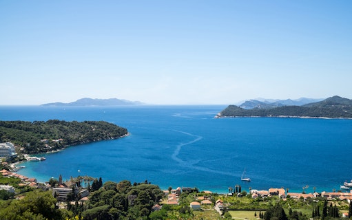 Dubrovnik Elaphites cruise view with islands and sailboats in the Adriatic Sea.