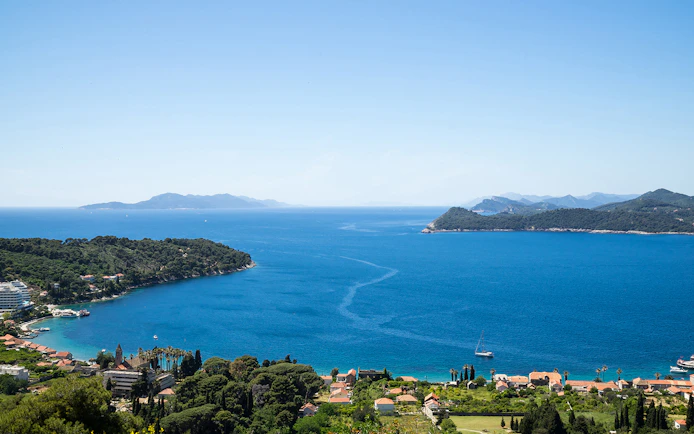 Dubrovnik Elaphites cruise view with islands and sailboats in the Adriatic Sea.