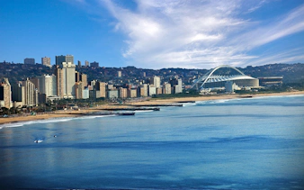 Durban skyline with Moses Mabhida Stadium and beachfront, South Africa.