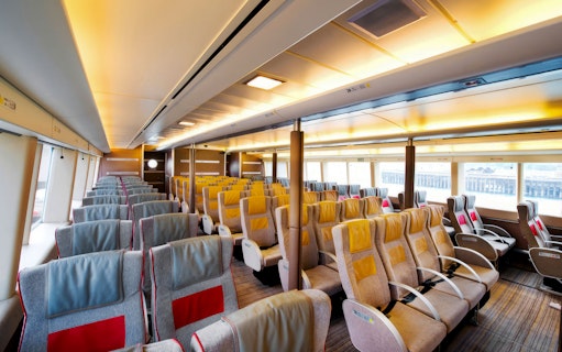 Turbojet ferry interior with rows of seats for HK to Macau round trip.