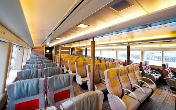 Turbojet ferry interior with rows of seats for HK to Macau round trip.