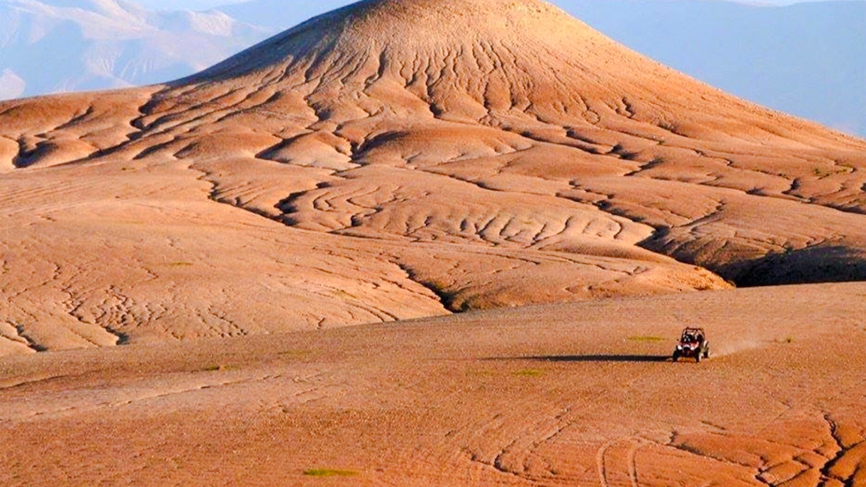 ATV driving across the Agafay Desert landscape near Marrakesh.