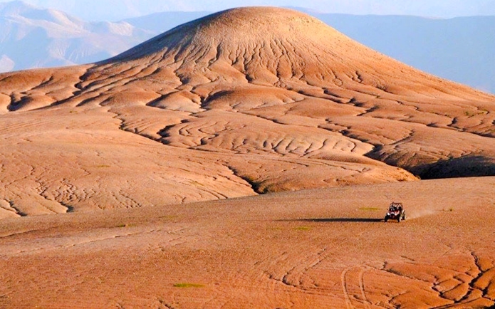 ATV driving across the Agafay Desert landscape near Marrakesh.