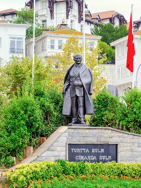 Statue of Mustafa Kemal Ataturk on Princes' Island, Turkey, with surrounding greenery.