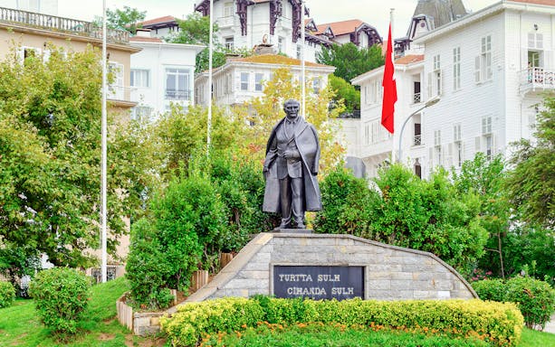 Statue of Mustafa Kemal Ataturk on Princes' Island, Turkey, with surrounding greenery.