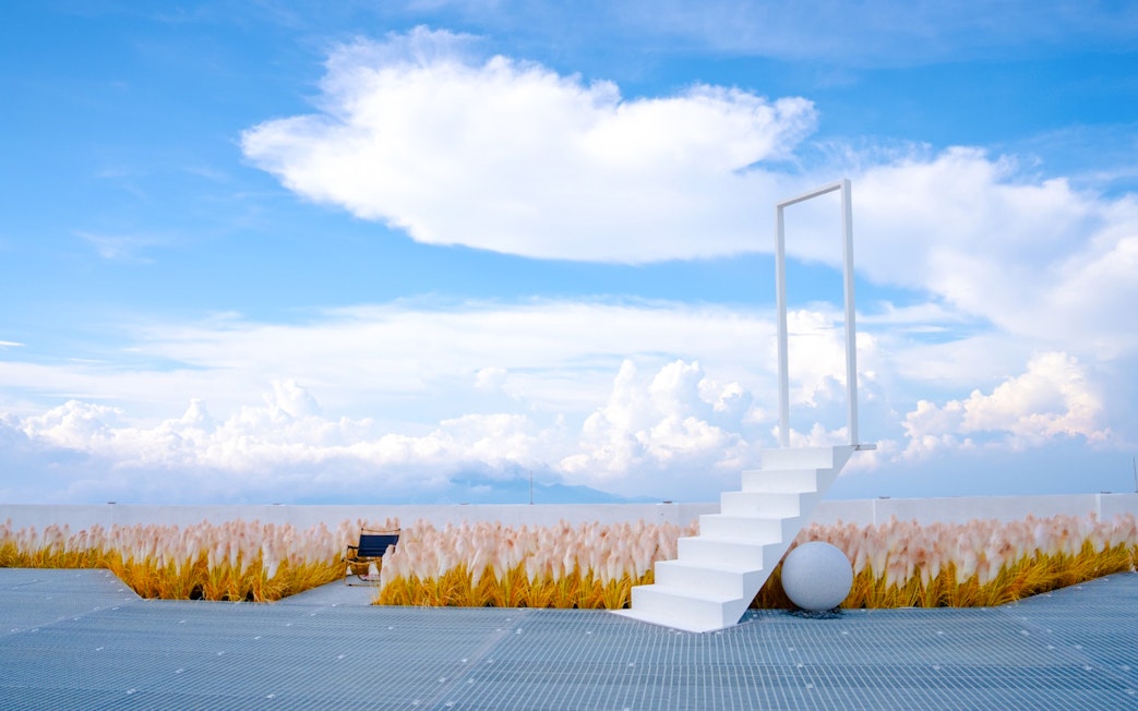 Staircase leading to a door frame against a cloudy sky at Hoverland, Wyndham Ion Majestic Hotel, Genting Highlands.