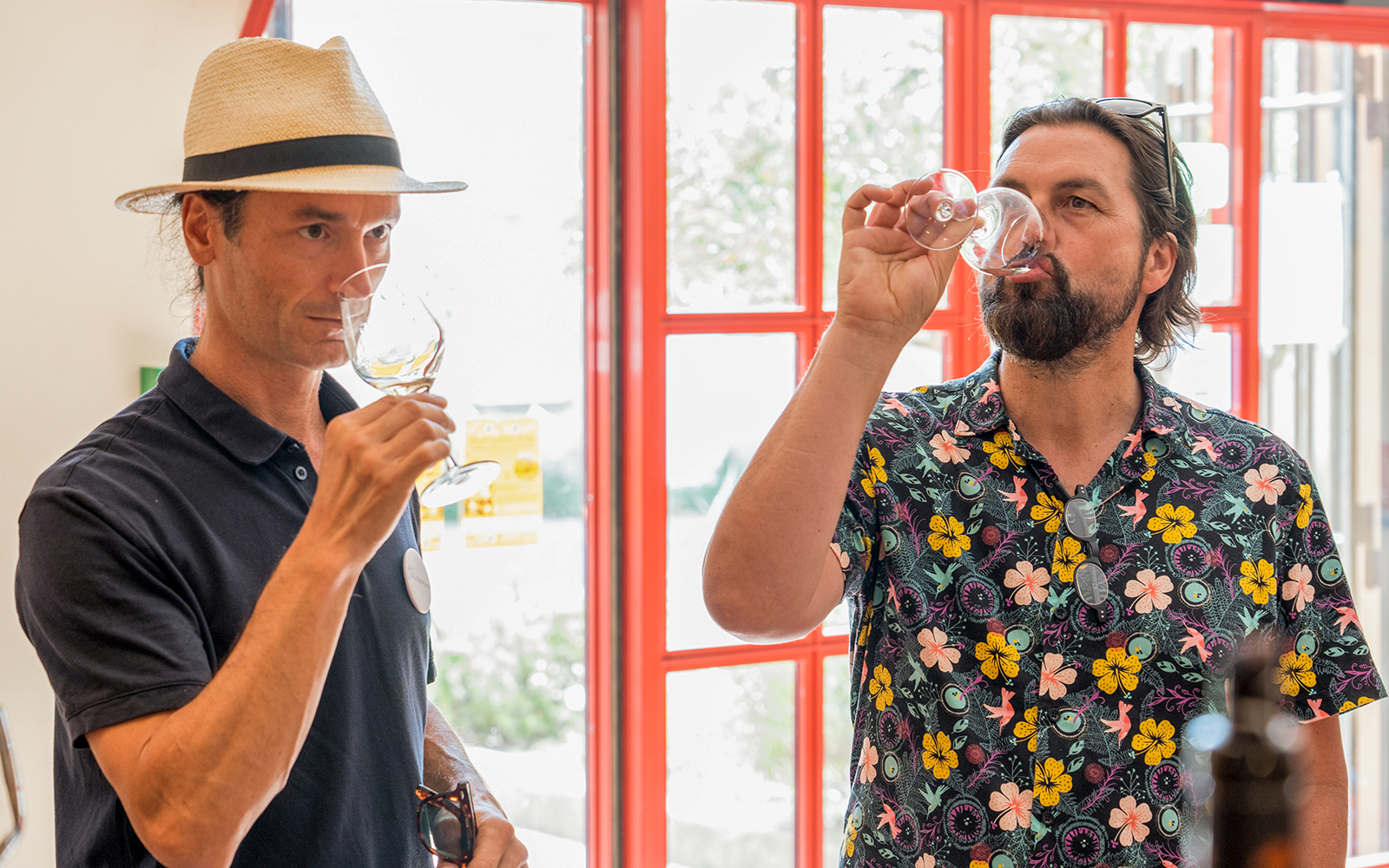 Wine tasting experience in Chateauneuf du Pape with two people sampling wine indoors.