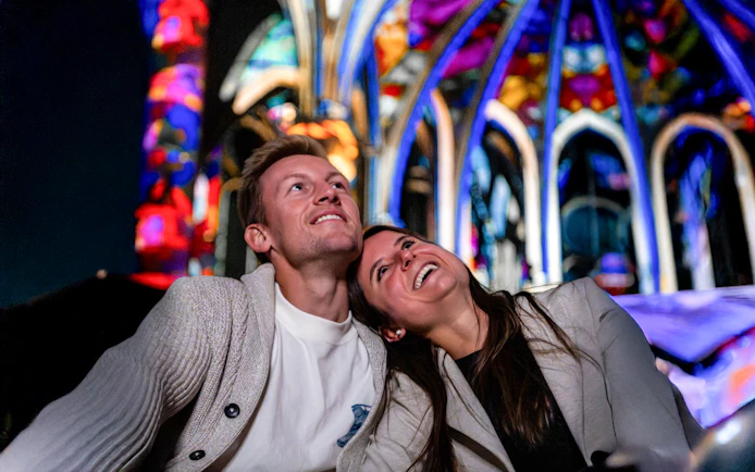 Couple enjoying light display at Westminster Cathedral, London.