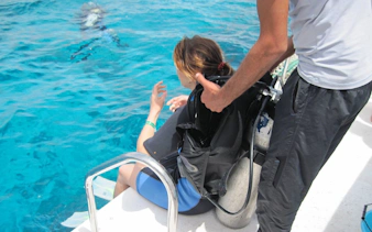 Beginner scuba diver preparing to enter Red Sea, Hurghada.