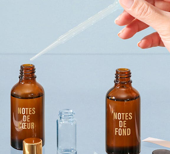 Perfume blending with pipette and Fargonard bottles.