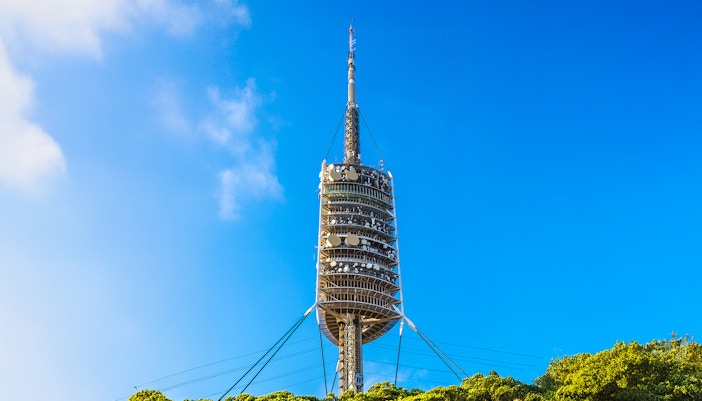 Torre de Collserola TV tower against blue sky in Barcelona.
