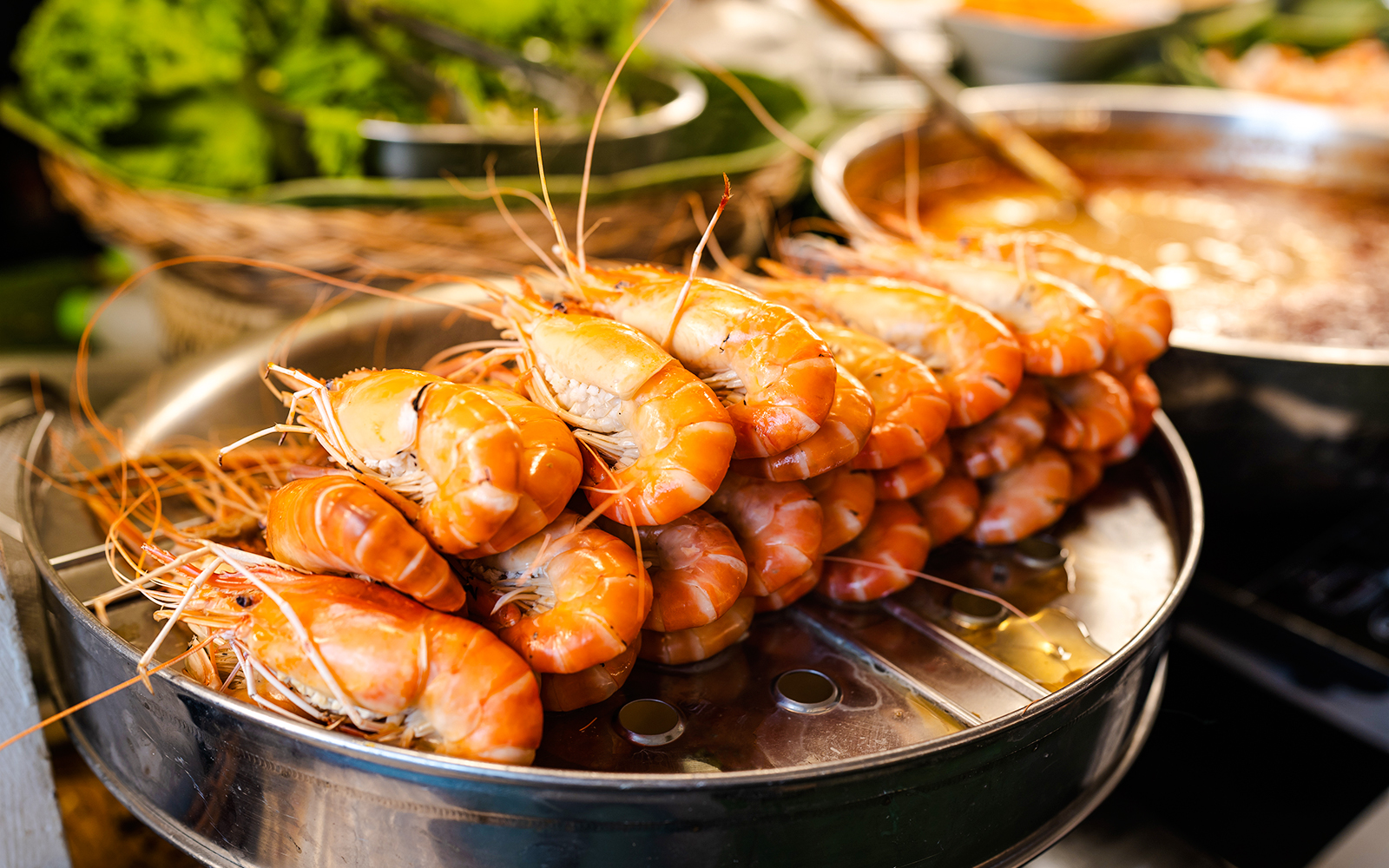 Steamed prawns served in a restaurant setting.