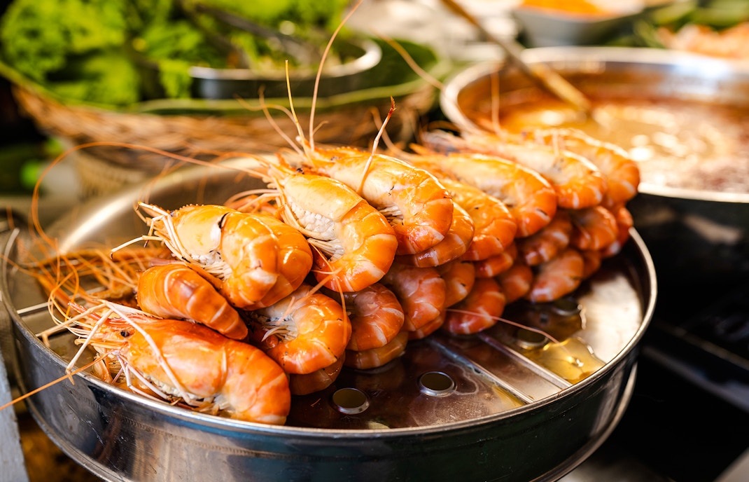 Steamed prawns served in a restaurant setting.