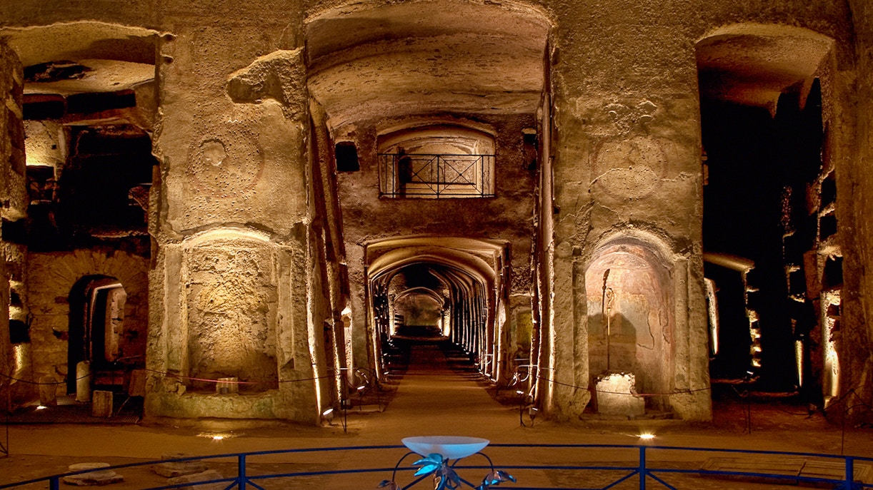 Guided tour inside the Catacombs of San Gennaro, Naples, showcasing ancient frescoes and burial sites.