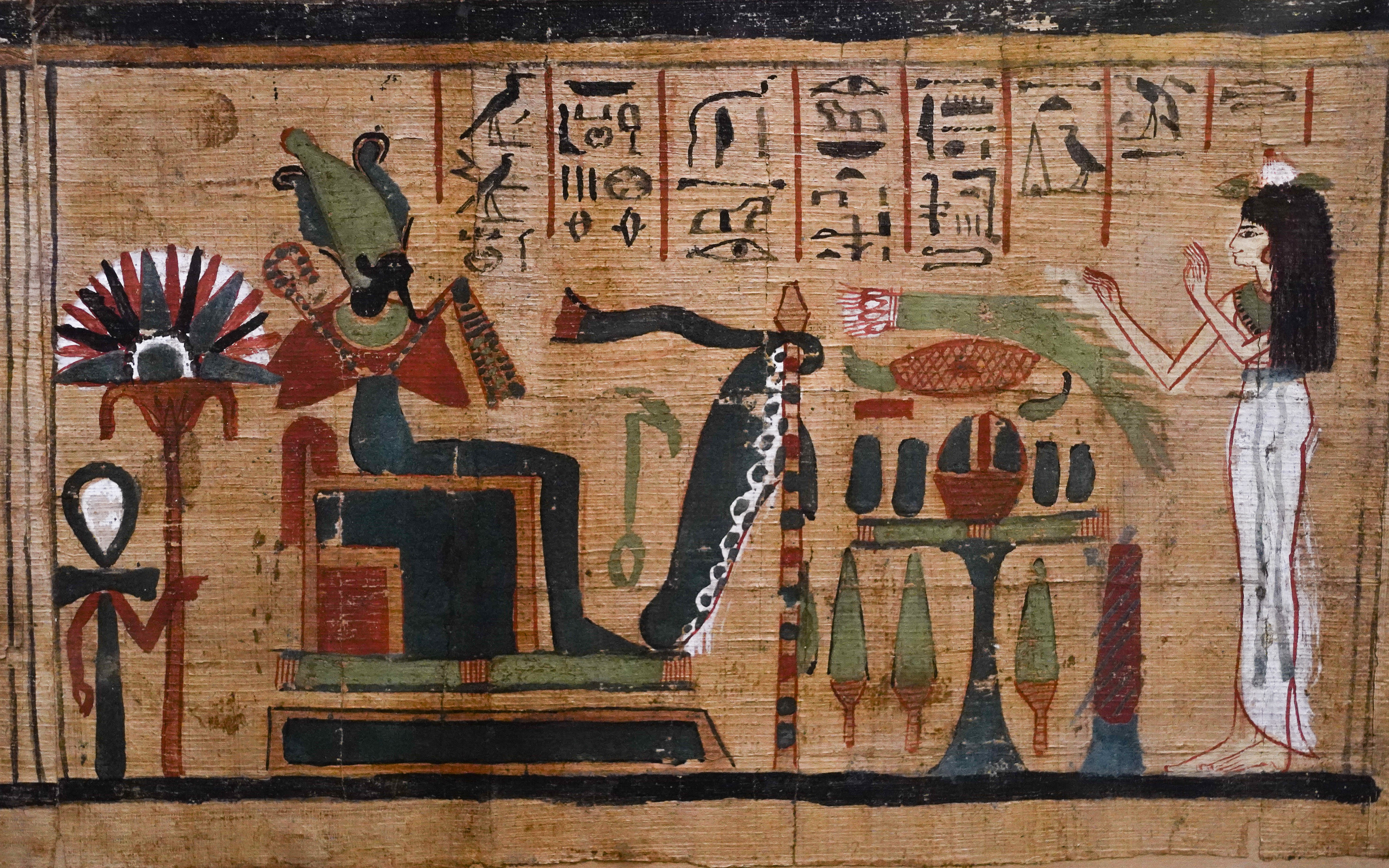 Ancient Egyptian papyrus painting with hieroglyphics and deities.