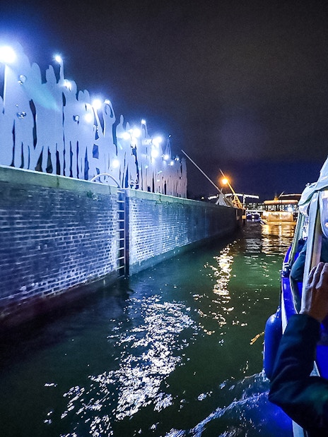 Small-group cruise viewing illuminated art installation during Amsterdam Light Festival.