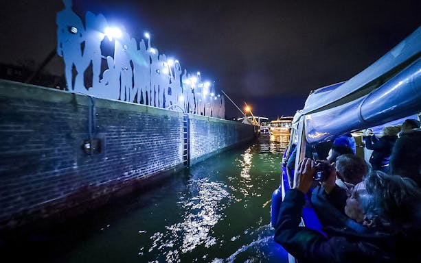 Small-group cruise viewing illuminated art installation during Amsterdam Light Festival.