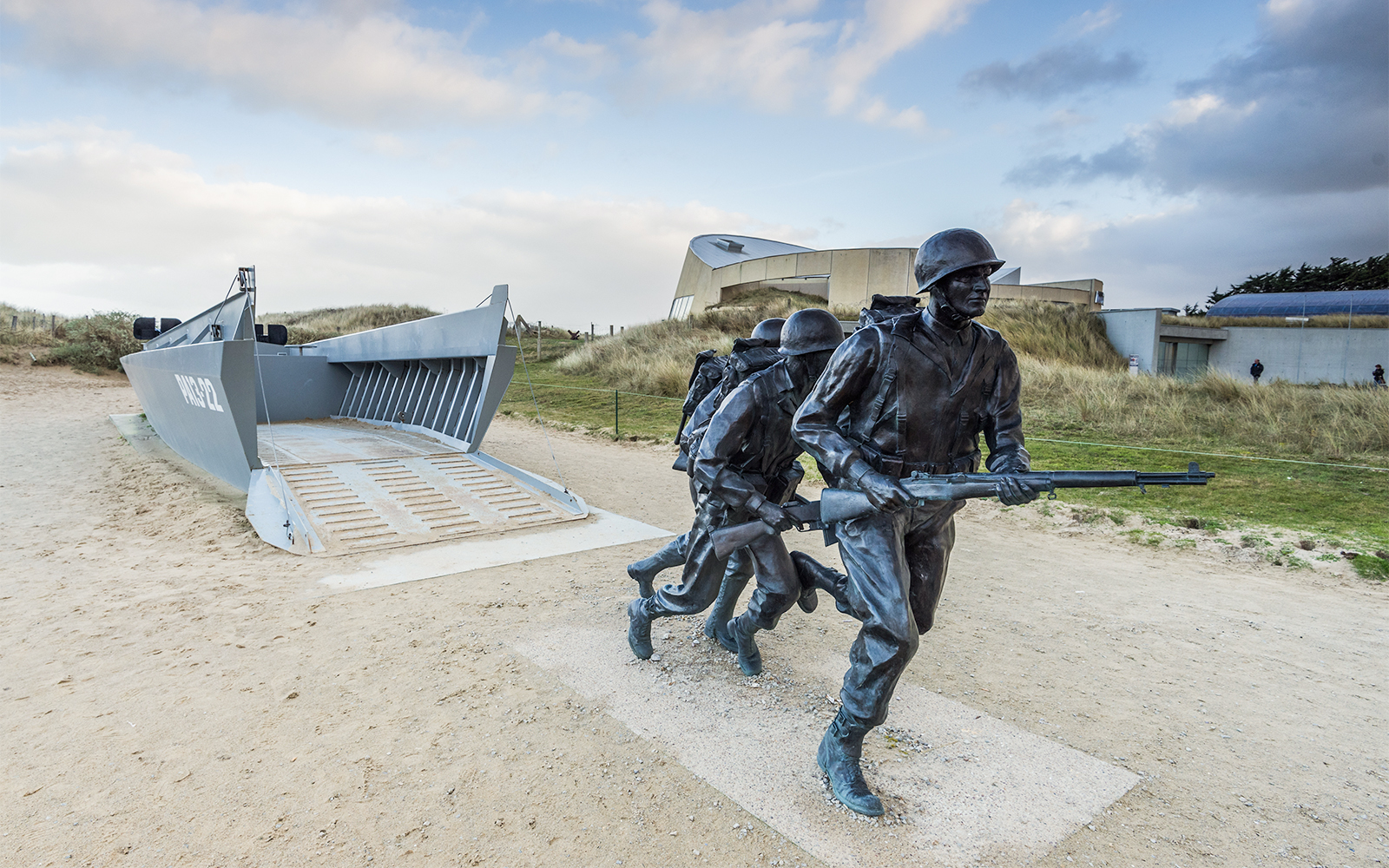 Normandy D-Day Tour visitors exploring Omaha Beach memorial site in France.