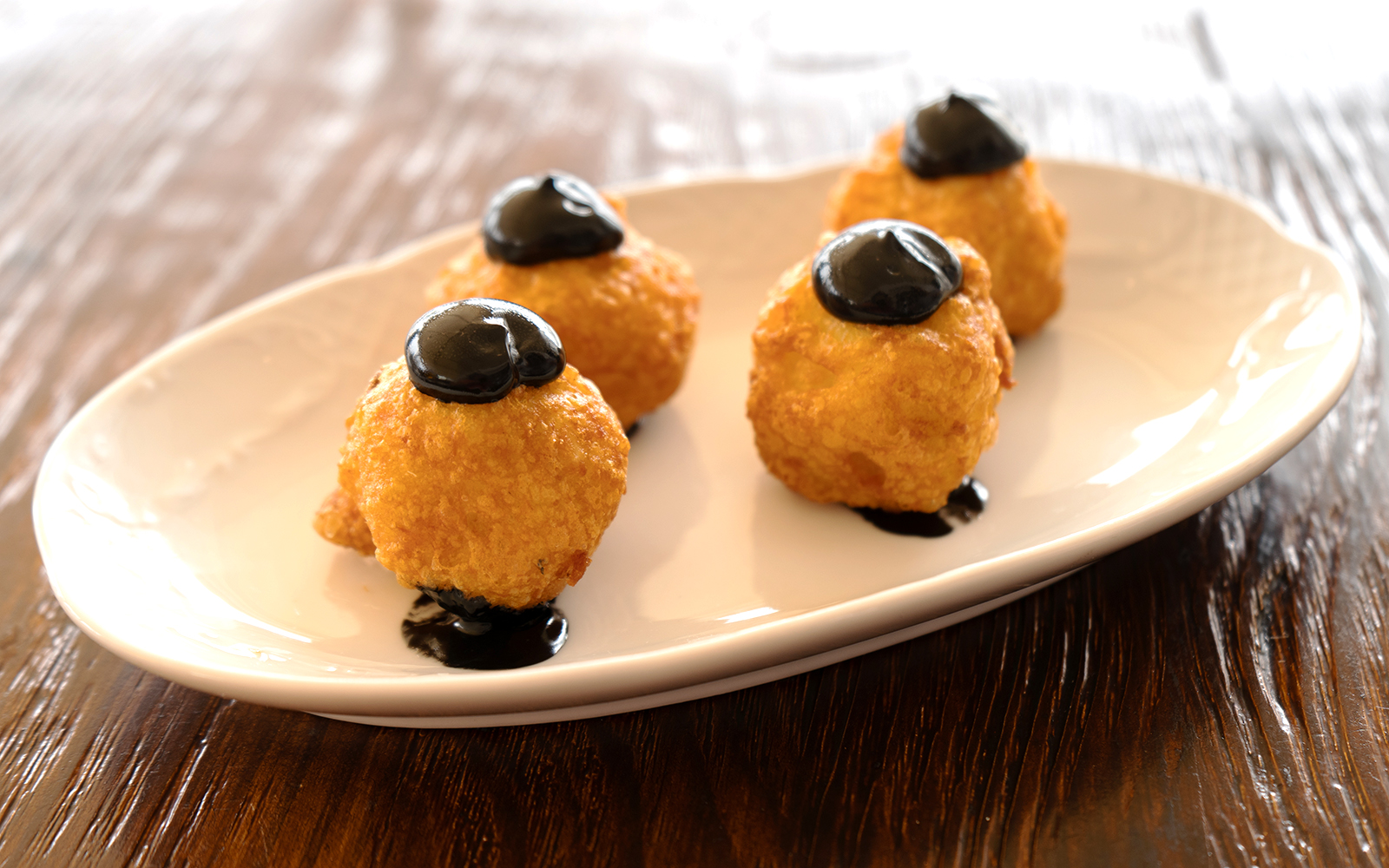 Squid ink croquettes served on a plate in Mallorca.
