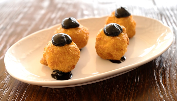 Squid ink croquettes served on a plate in Mallorca.