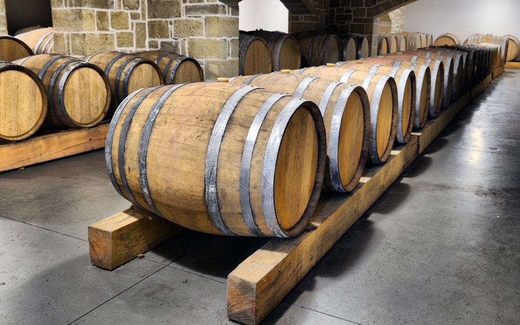 Wine barrels in a cellar during Chianti wine tasting tour from Florence.