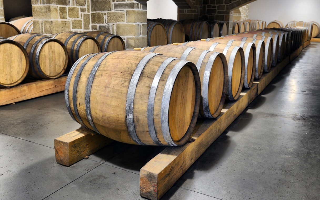 Wine barrels in a cellar during Chianti wine tasting tour from Florence.