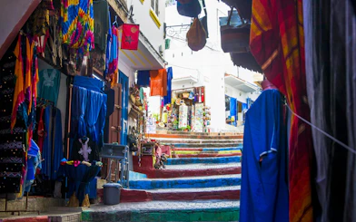 Colorful textiles and goods displayed at a local market in Tangier, Morocco.