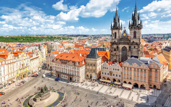 Prague Castle tour group exploring historic architecture in Old Town Square.