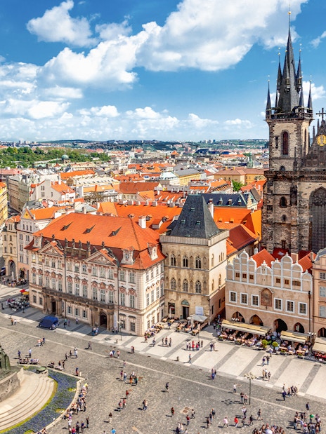 Prague Castle tour group exploring historic architecture in Old Town Square.