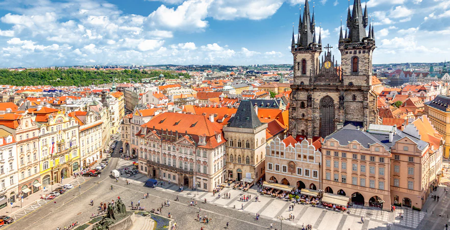 Prague Castle tour group exploring historic architecture in Old Town Square.