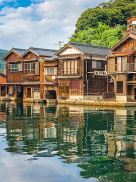 Ine Funaya waterfront boathouses reflecting on water, Kyoto Coastal Tour.