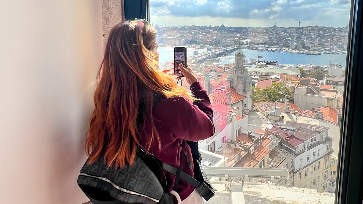 Tourist admiring the view from Galata Tower, Istanbul.