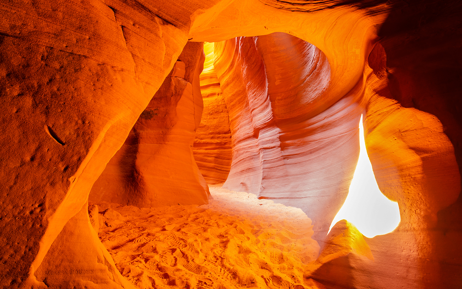 Antelope Canyon X sandstone formations with sunlight filtering through.
