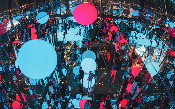 Akara Sky Hanuman observatory in Bangkok with mirror deck and floating light orbs.