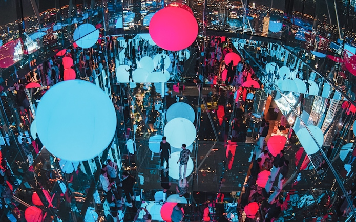 Akara Sky Hanuman observatory in Bangkok with mirror deck and floating light orbs.