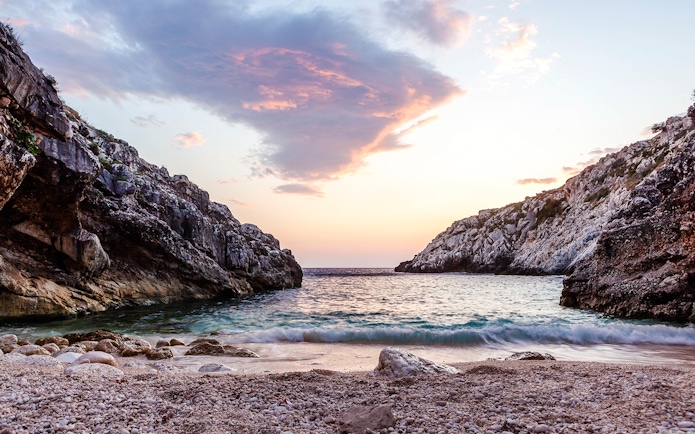 Rocky coastline at sunset on the Karaburun Peninsula, Albania.