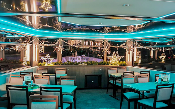Festive dining area with star lights on a Cologne Advent tour boat.