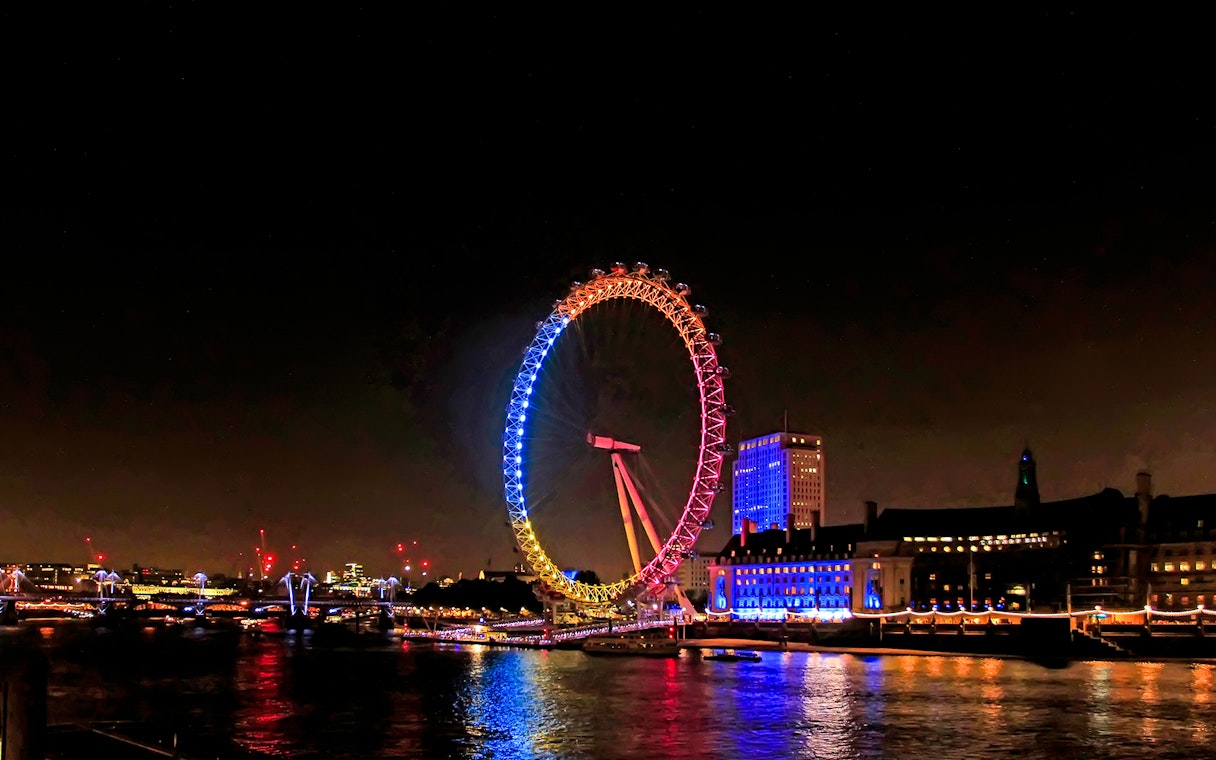London Eye illuminated at night during Big Bus Panoramic Evening Tour.