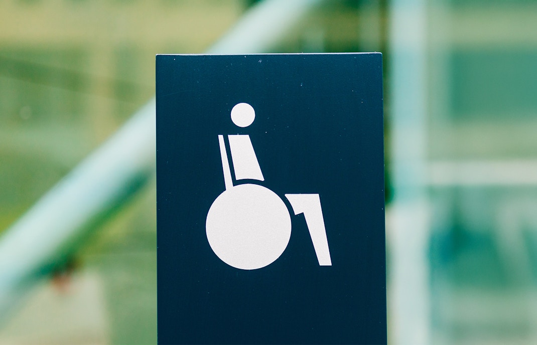 Wheelchair access sign indicating barrier-free entry.