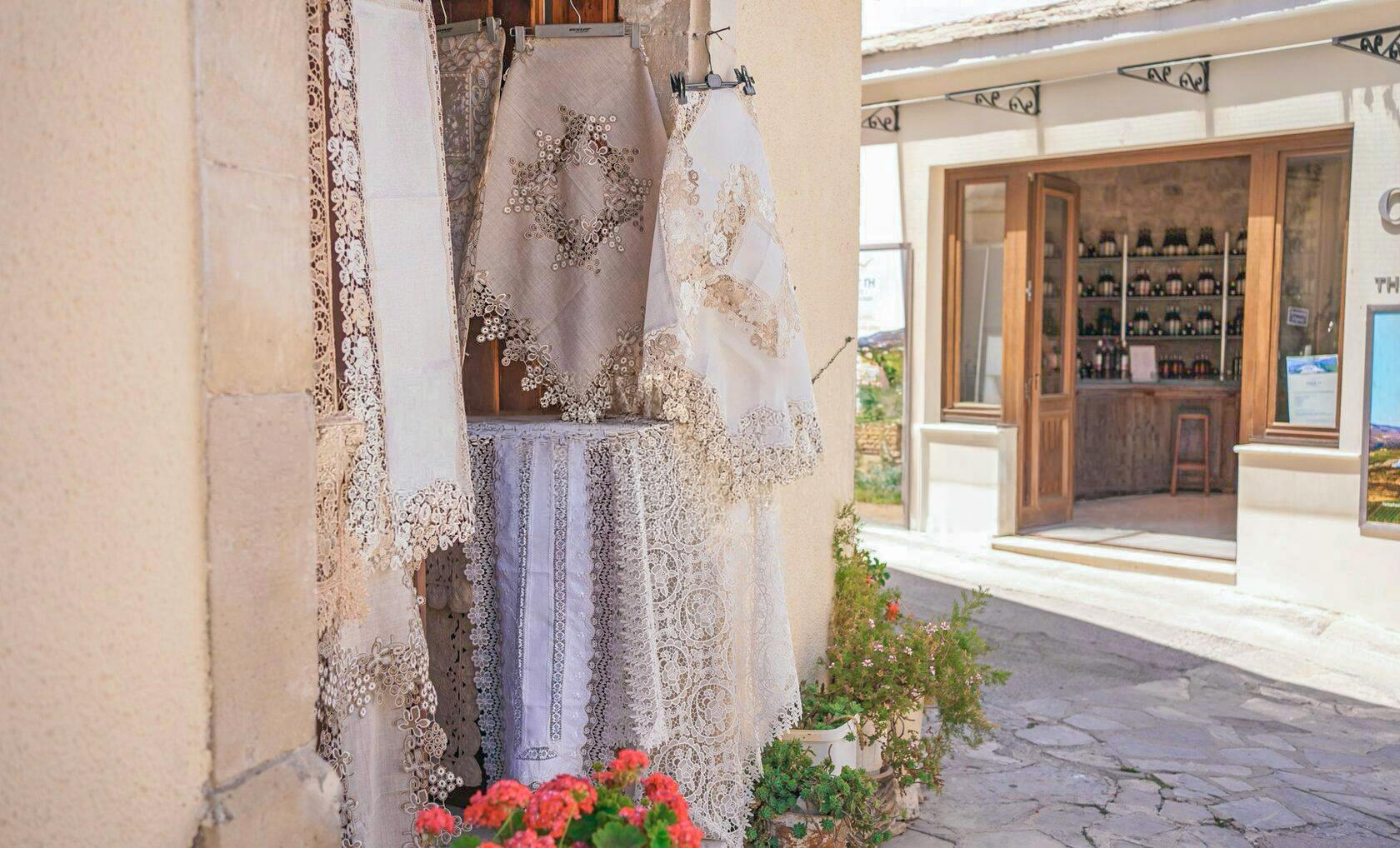 Lace textiles displayed outside a shop in a Troodos Mountains village, Cyprus.