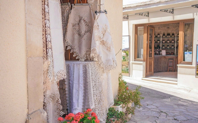 Lace textiles displayed outside a shop in a Troodos Mountains village, Cyprus.