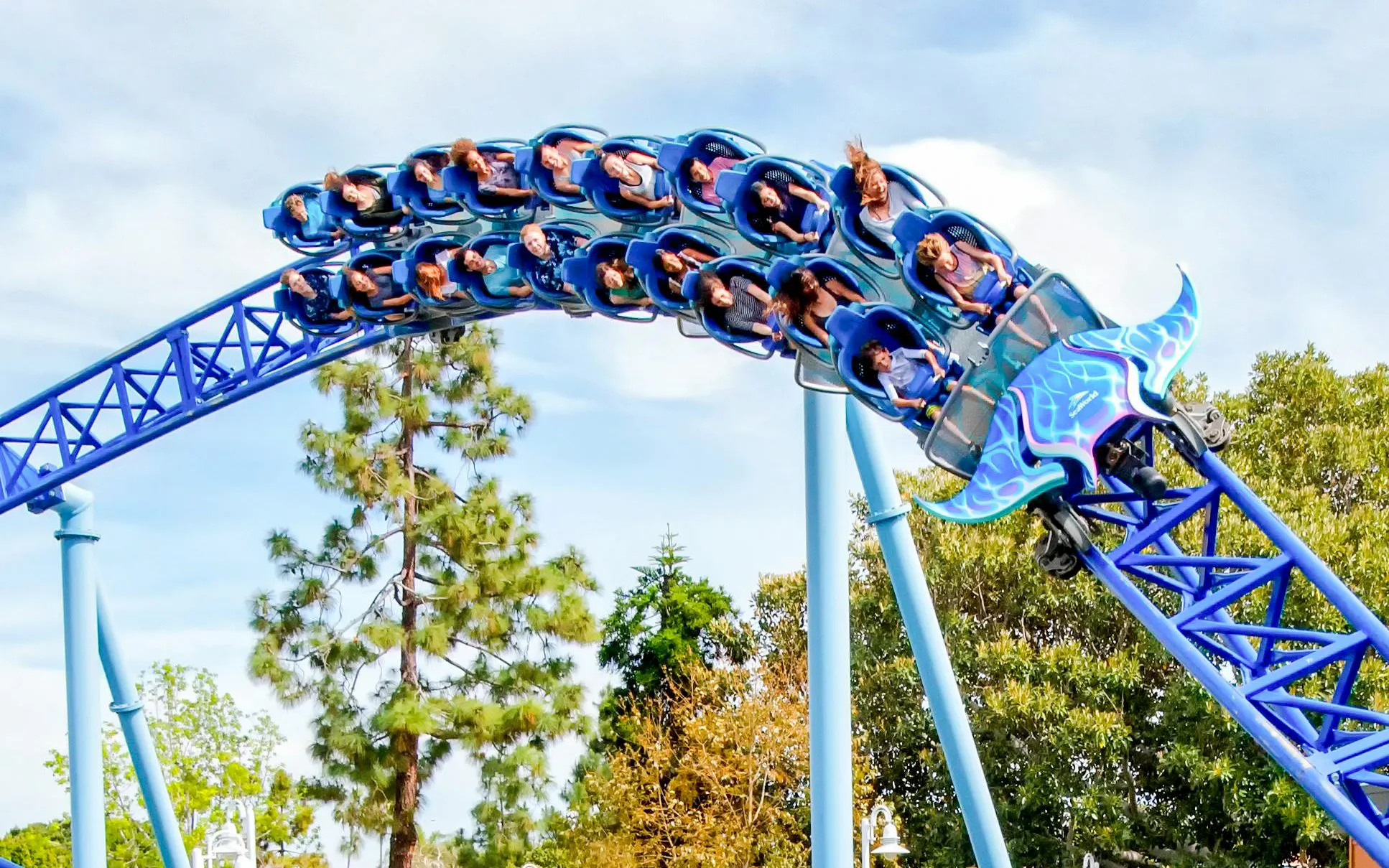 Roller coaster at SeaWorld San Diego with riders on a blue track.