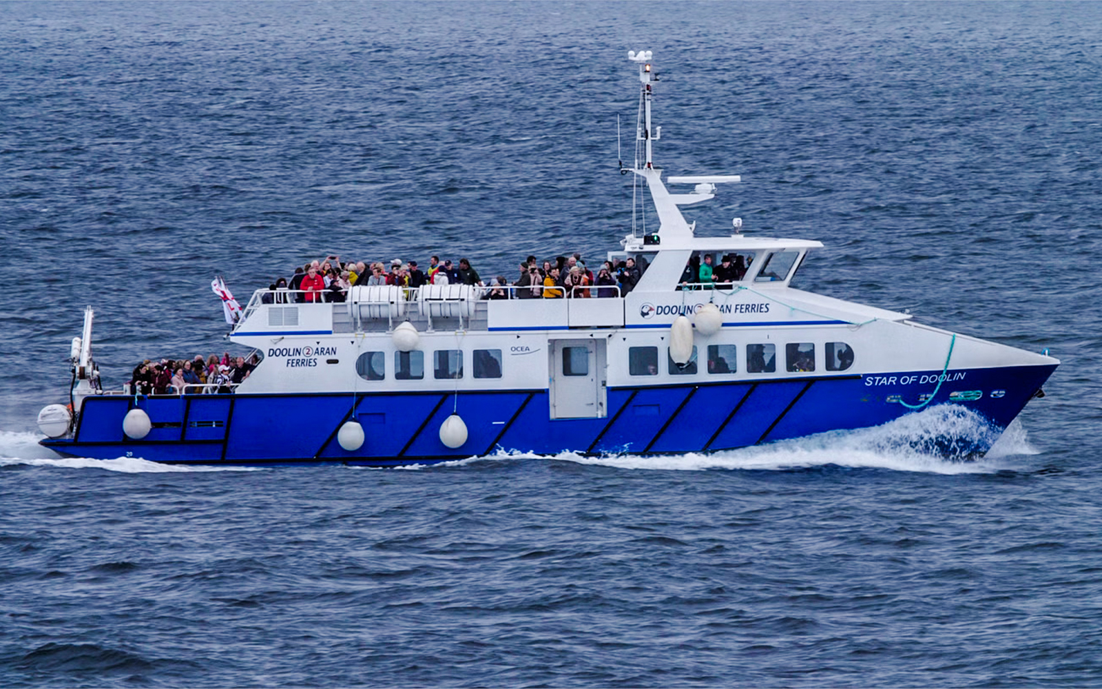 Ferry with passengers on Cliffs of Moher cruise in Ireland.