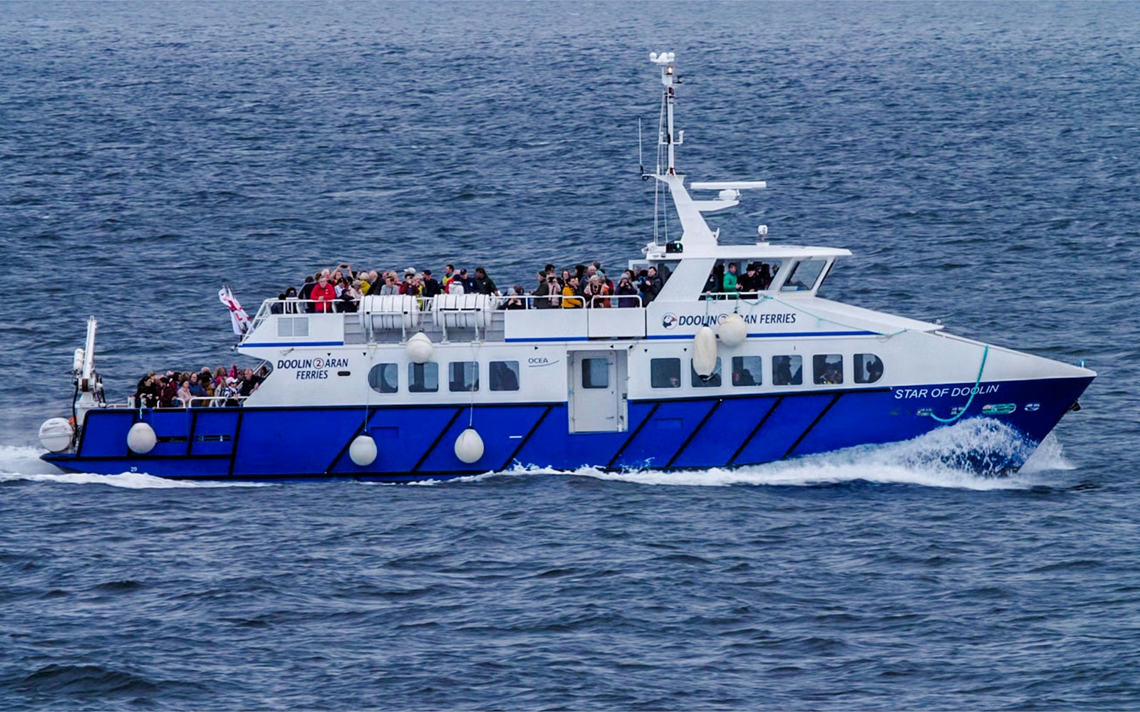 Ferry with passengers on Cliffs of Moher cruise in Ireland.