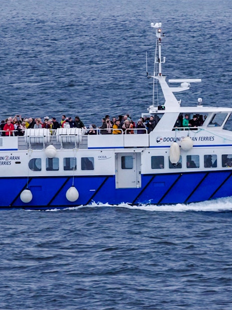Ferry with passengers on Cliffs of Moher cruise in Ireland.