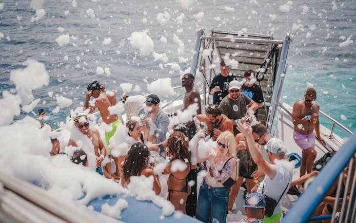 Tourists enjoying foam party on Cruise Crush Boat Party.