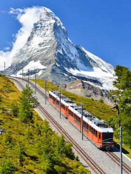 Gornergrat train traveling with Matterhorn in the background, Zermatt, Switzerland.