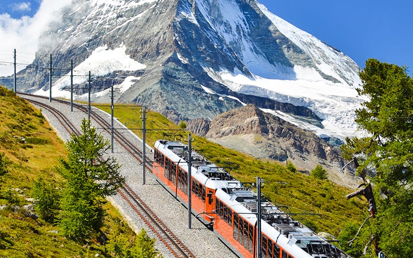 Gornergrat train traveling with Matterhorn in the background, Zermatt, Switzerland.