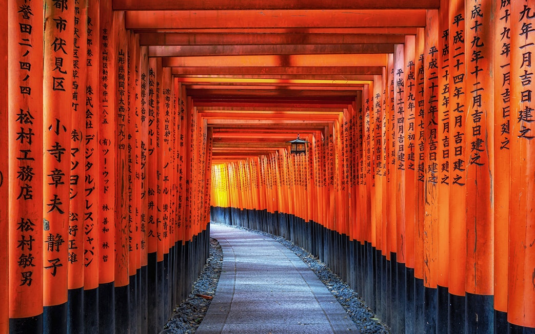 Pathway through red torii gates at Fushimi Inari Taisha Shrine, Kyoto.